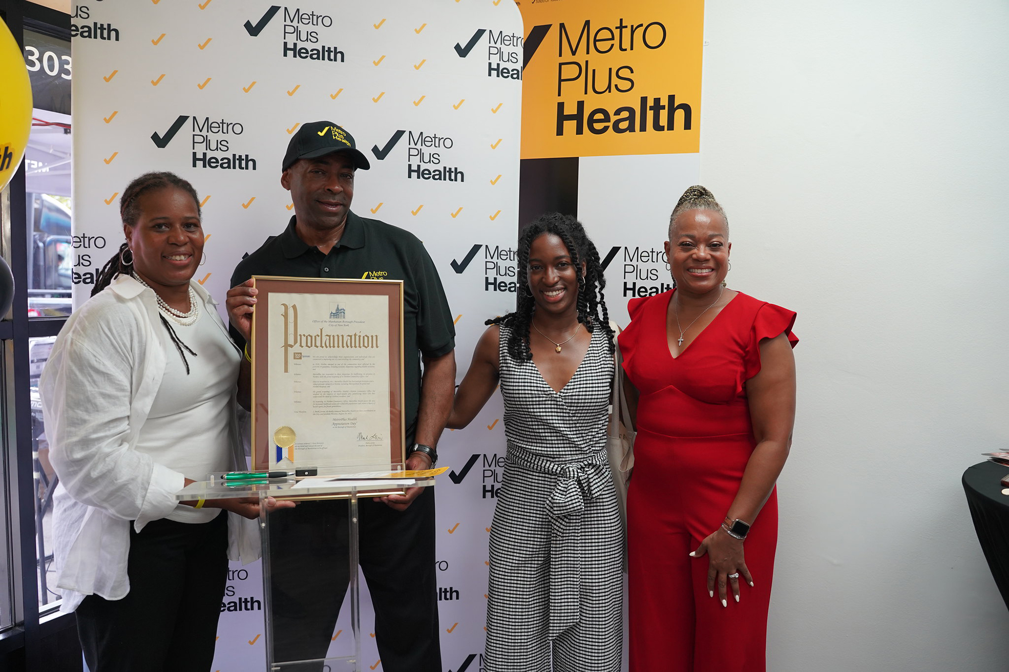 A team photo from the opening event holding a proclamation document