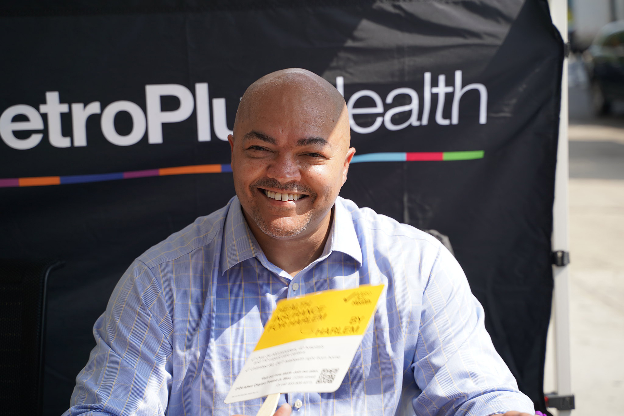 A man smiles from a an event booth