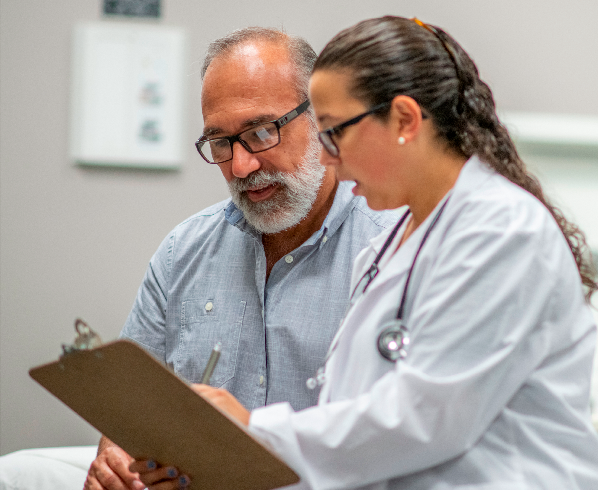 A doctor reviewing notes with a patient