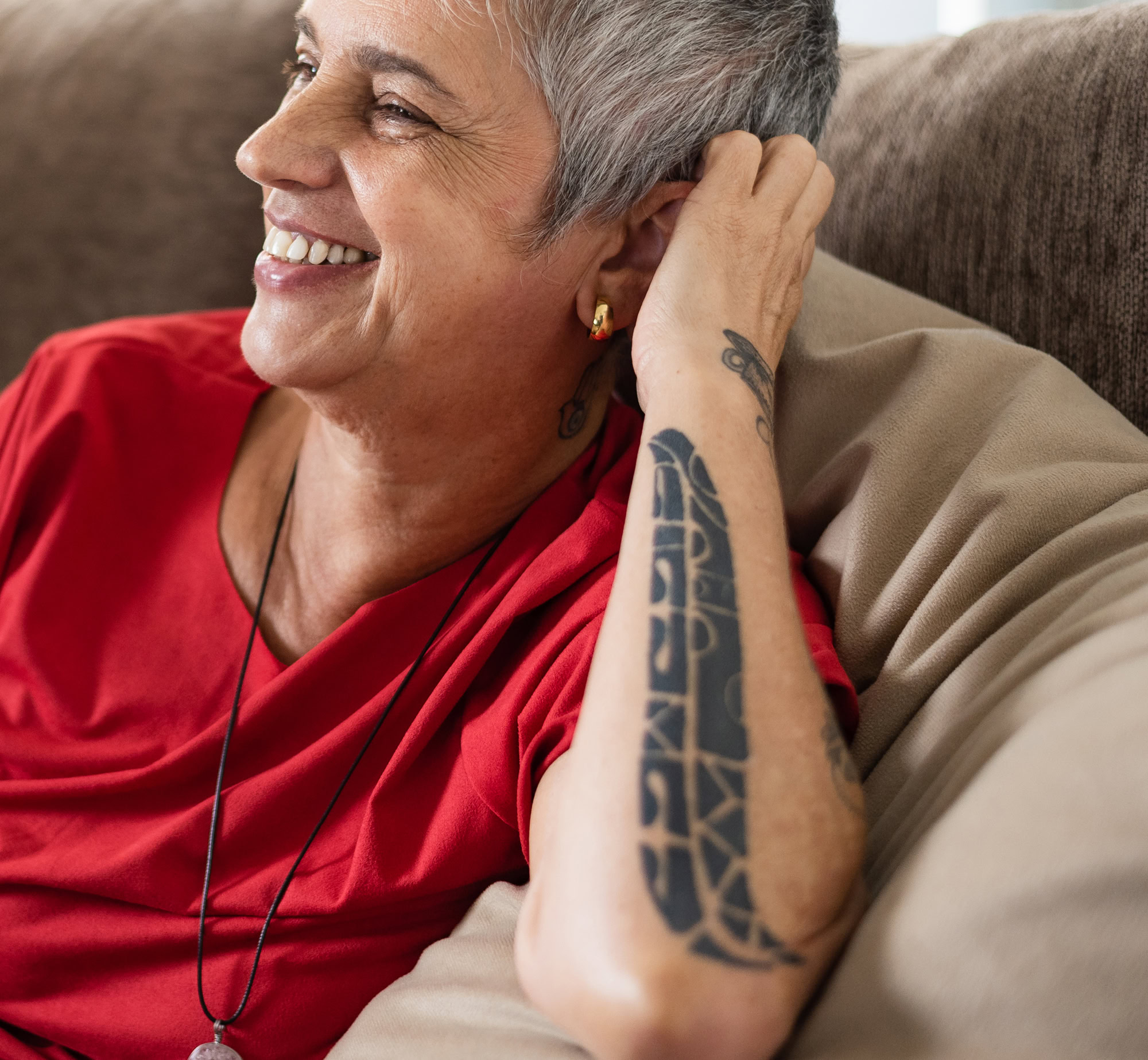 Profile of a person sitting on a couch and smiling