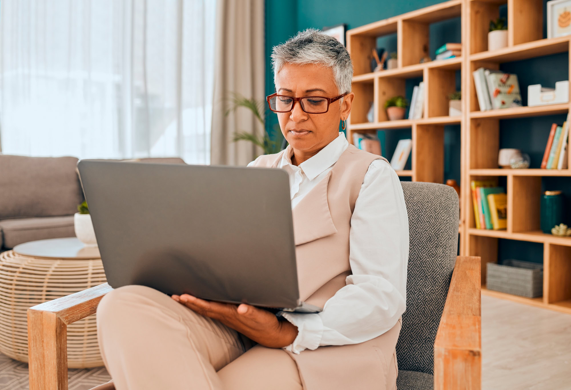 Mature psychologist, computer work and serious psychology doctor doing research in office. Therapist, reading and digital data planning of a mental health worker looking at online counseling notes