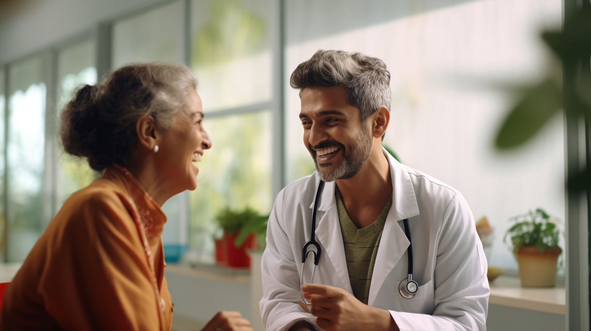 Smiling male doctor and senior patient are talking about therapy