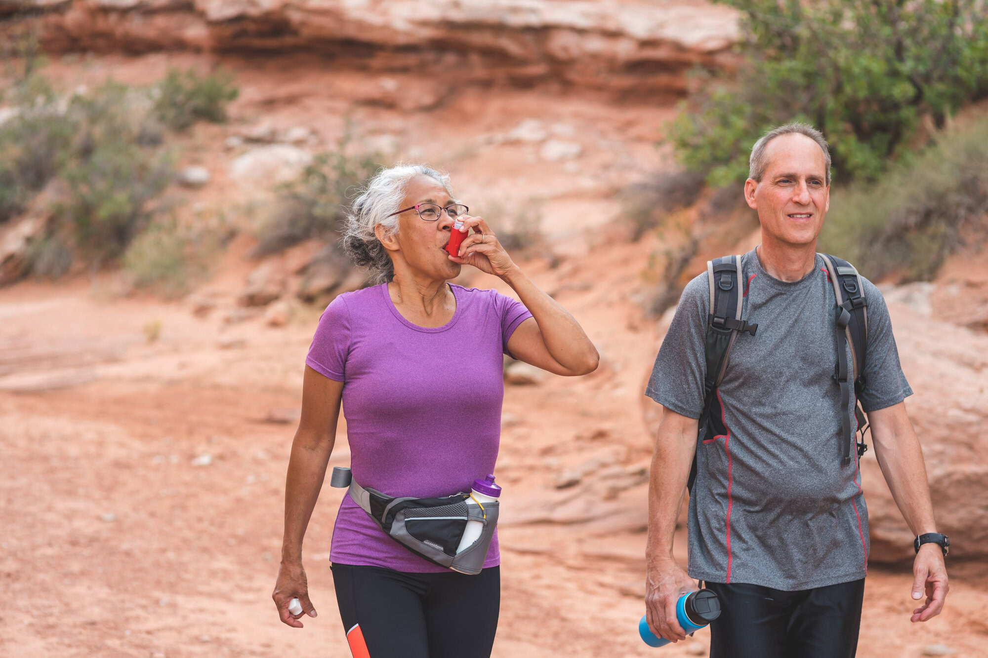Ab woman using her inhaler , promoting asthma awareness and management.