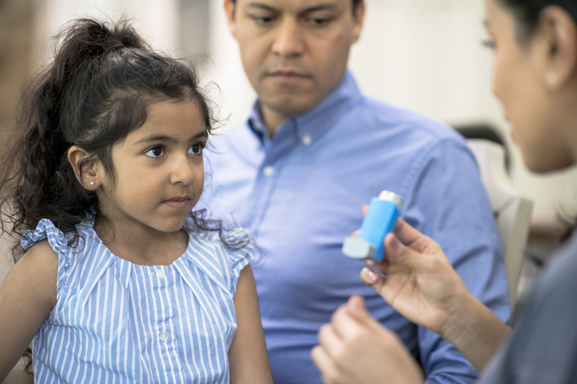 A doctor discussing asthma treatment options with a patient in a clinical setting.