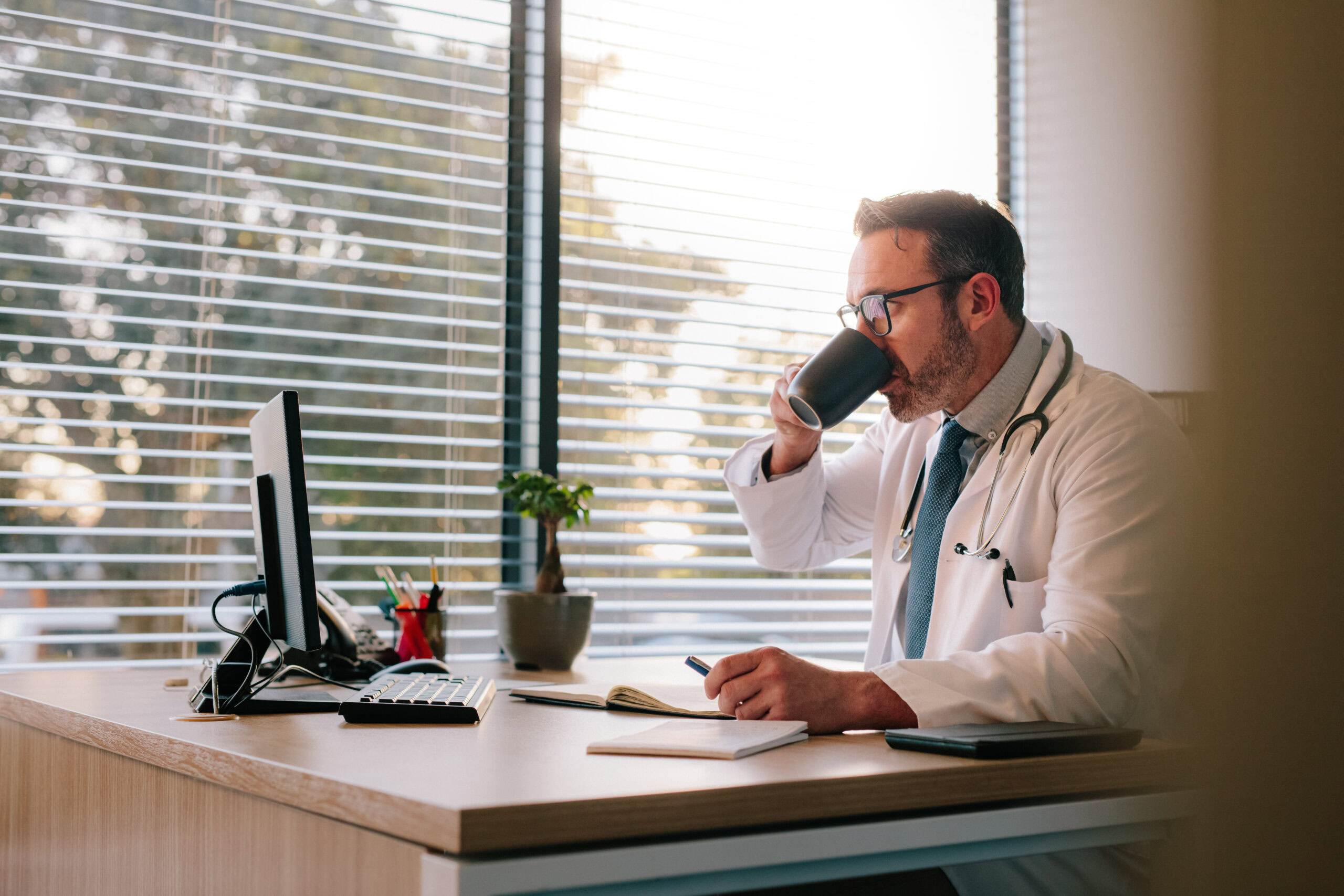 Healthcare provider completing an online application form on a laptop, representing the MetroPlusHealth provider enrollment process.